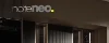 Cucina moderna con eleganti armadi e scaffali illuminati, NolteNeo.