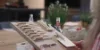 Una persona tiene materiali per hobby su un tavolo in una cucina moderna di Nolte Kitchen.