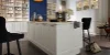Cucina moderna con isola bianca e parete blu sullo sfondo, Nolte Kitchen.