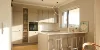 Cucina moderna e luminosa con isola e sgabelli da bar, progettata da Nolte Kitchen.