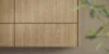 Armadio in legno in una cucina moderna con piante in primo piano, Nolte Kitchen.