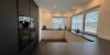 Modern kitchen with dark cabinets and large windows, Nolte Kitchen.