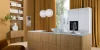 Nolte Kitchen: Cocina moderna con isla de madera, cortinas doradas y estanterías blancas.