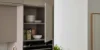 Un armadio da cucina aperto con stoviglie e un forno sotto di Nolte Kitchen.