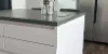 Cucina moderna con isola bianca e elettrodomestici in acciaio inox, Nolte Kitchen.