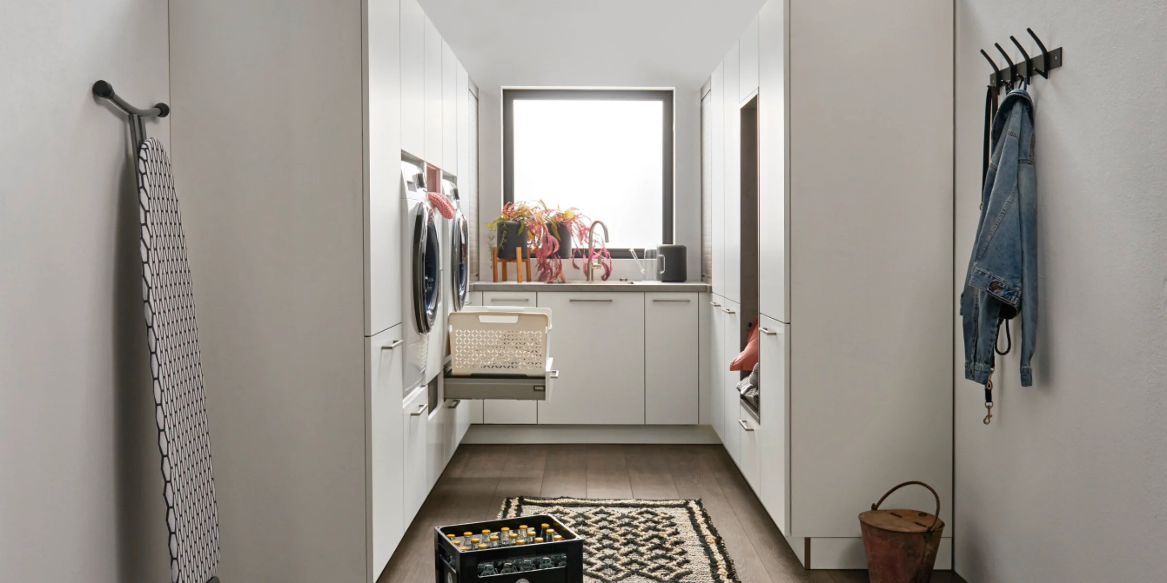 Hauswirtschaftsraum di Nolte Küchen, mit dem Frontenprogramm FEEL in Weiß Softmatt, molto spazio di archiviazione, Gerätenische, Auszugskorb und modernem Design.