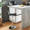 Cucina moderna con bancone e sgabelli, piante e arredi luminosi; Nolte Kitchen.