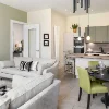 Soggiorno con arredi moderni, zona pranzo e cucina a vista, progettato da Nolte Living.