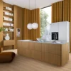 Nolte Kitchen: Cocina moderna con isla de madera, cortinas doradas y estanterías blancas.