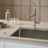Cucina moderna con lavello in acciaio inox e piano in legno, arricchita da "Nolte Kitchen".