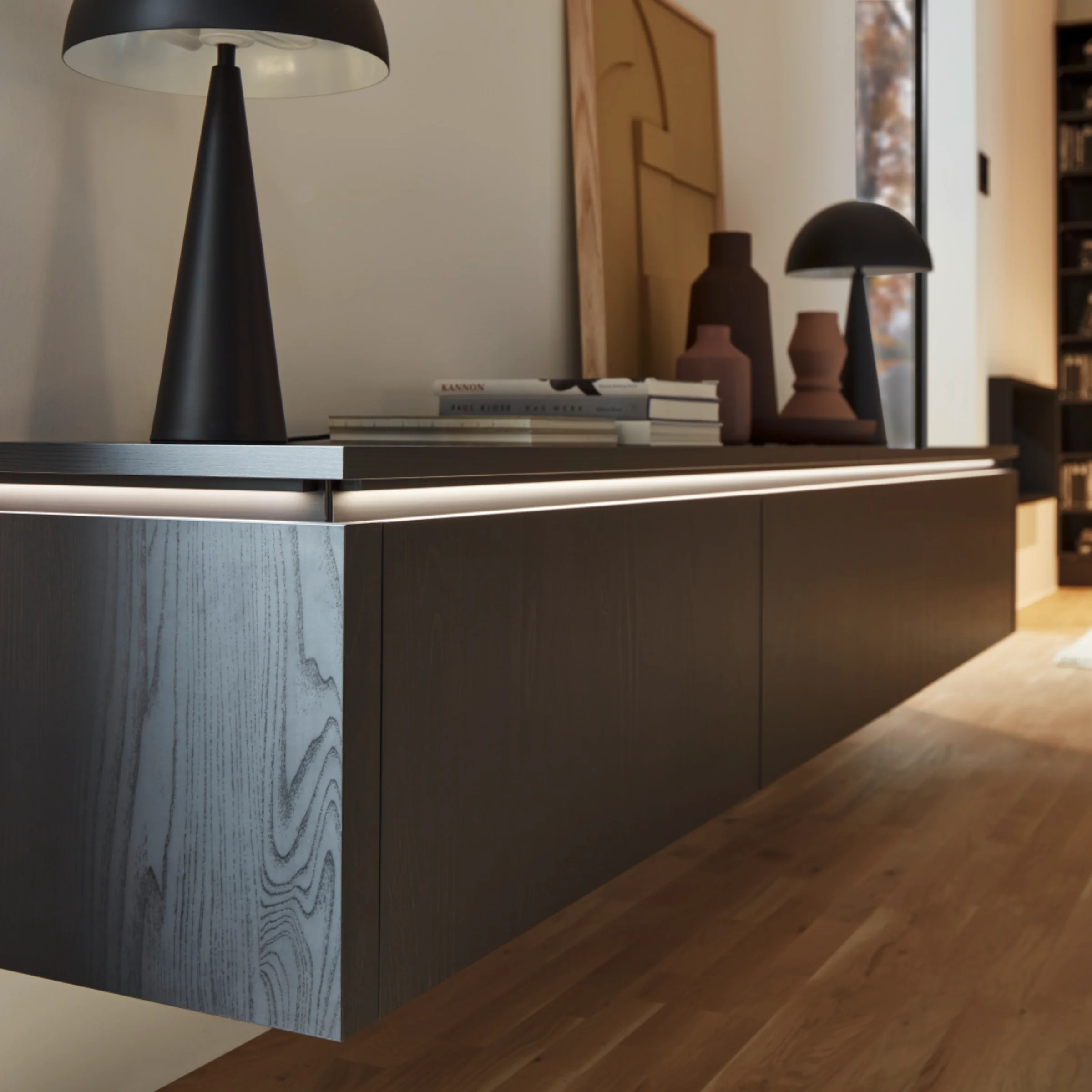 Un moderno soggiorno con mobile sospeso e elementi decorativi; Nolte Living.