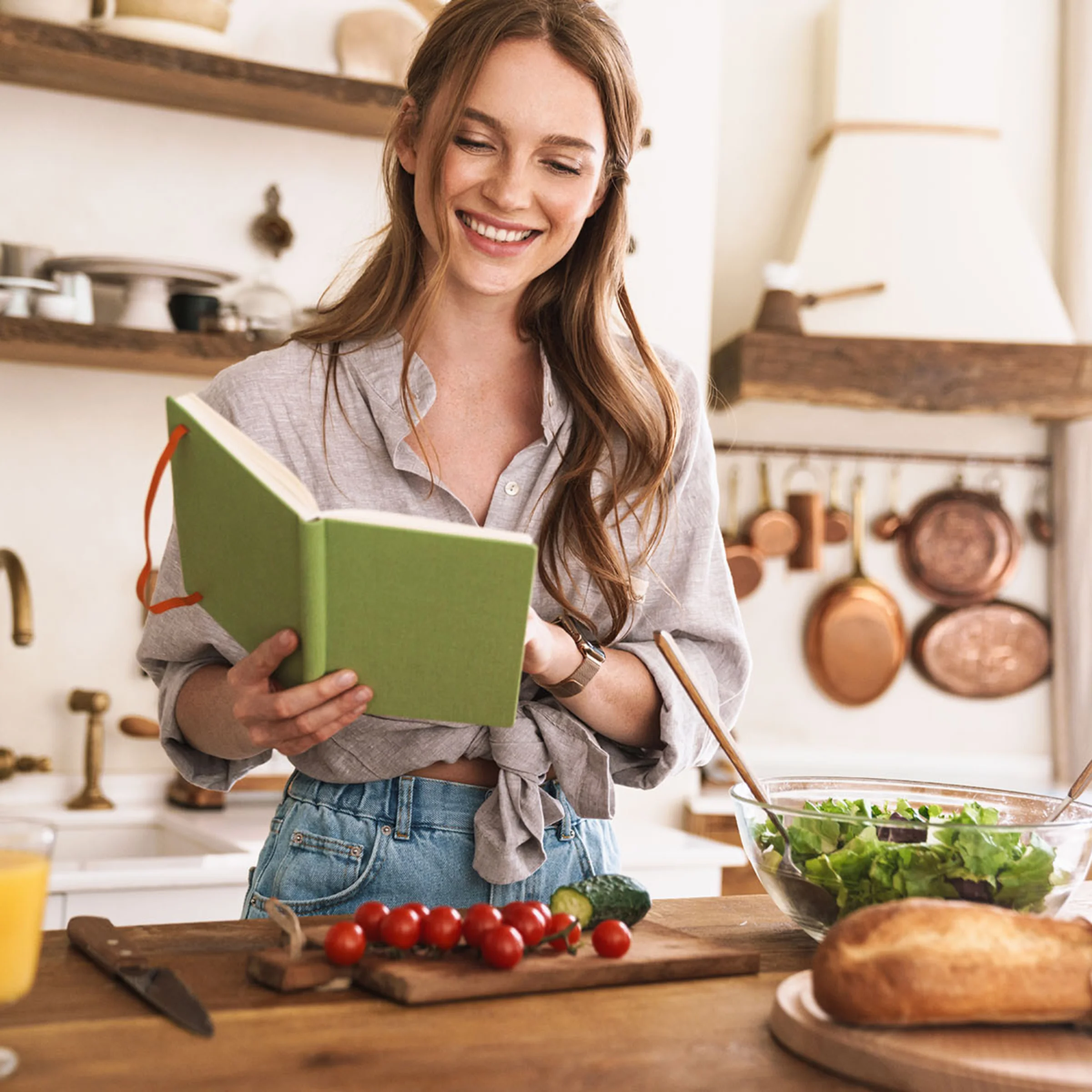 Una donna cucina in una cucina con ingredienti freschi, Nolte Kitchen.