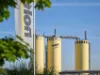Three yellow silos with Nolte Kitchen logo against a blue sky.