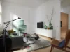 Un moderno soggiorno con mobili e decorazioni eleganti, Nolte Living.