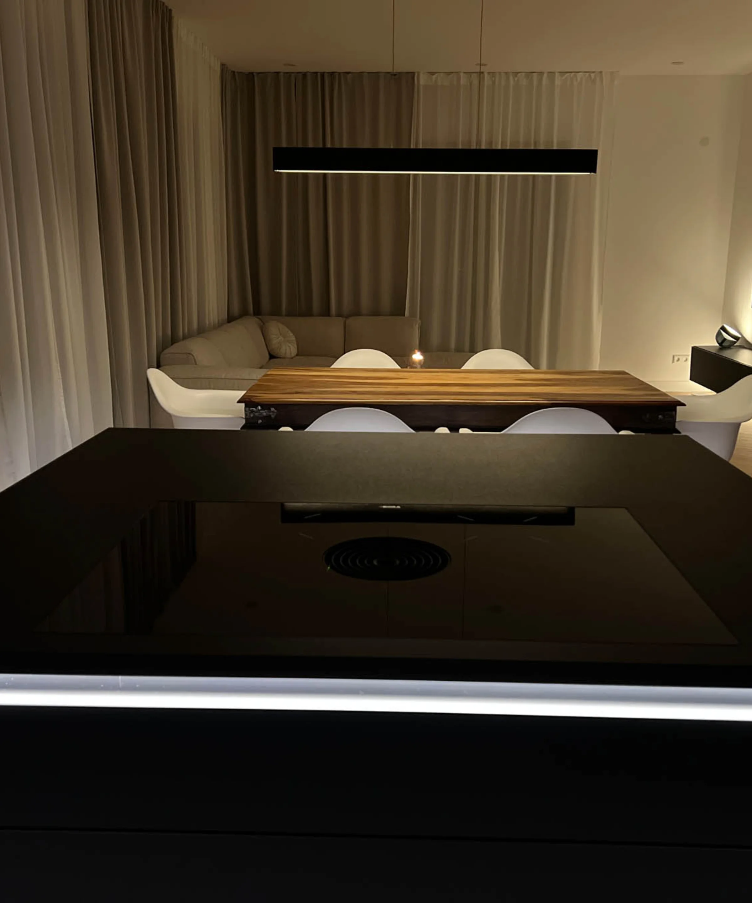 Soggiorno moderno con tavolo da pranzo e divano in un design elegante di Nolte Living.