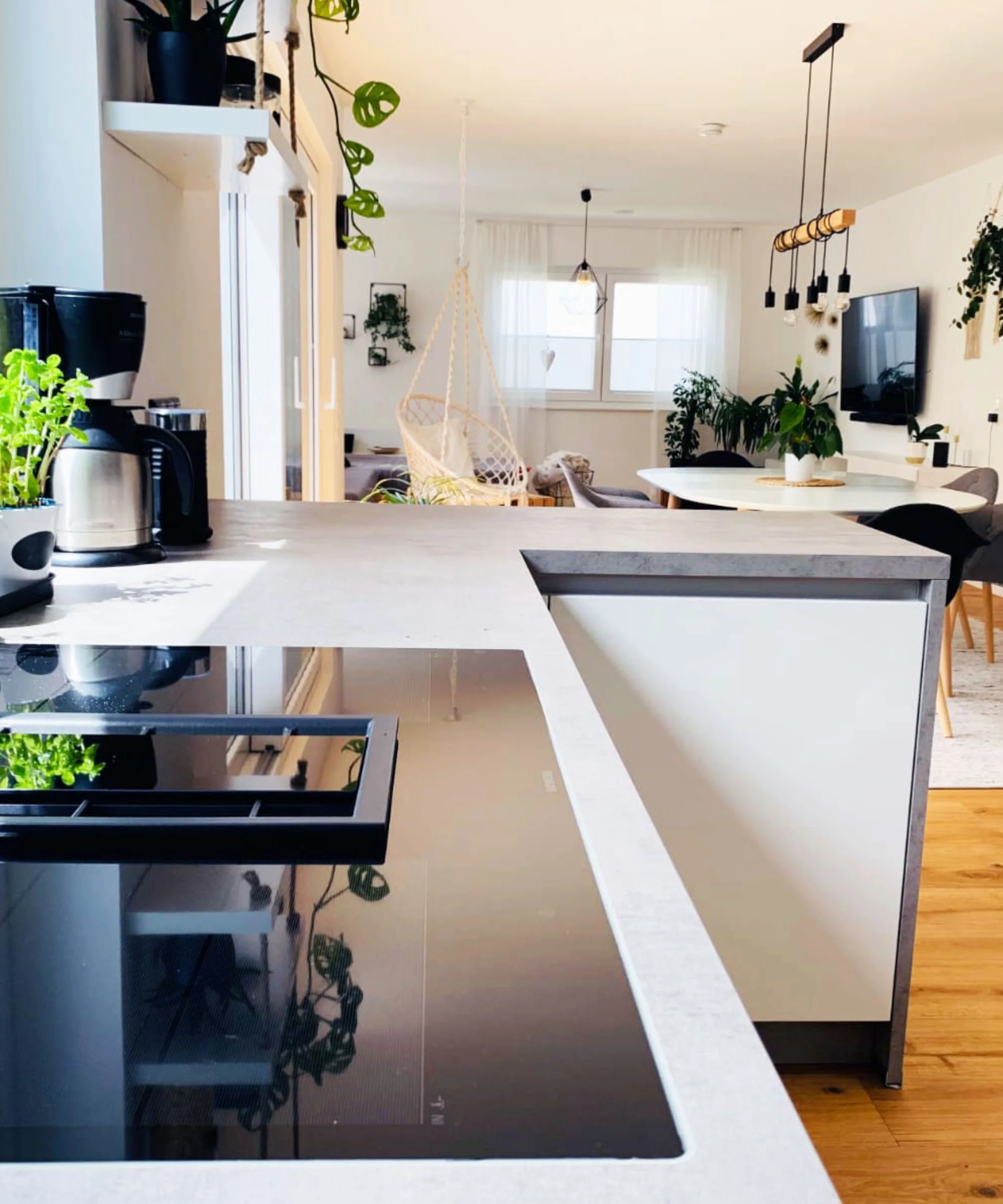Cucina moderna con piante e zona pranzo, parte della collezione Nolte Kitchen.